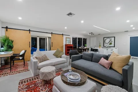 a living room with furniture and a wooden floor