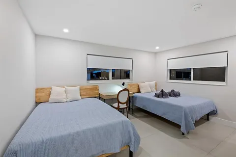 a bedroom with two beds and a couch