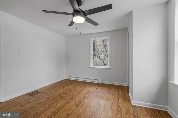 wooden floor in an empty room with a window