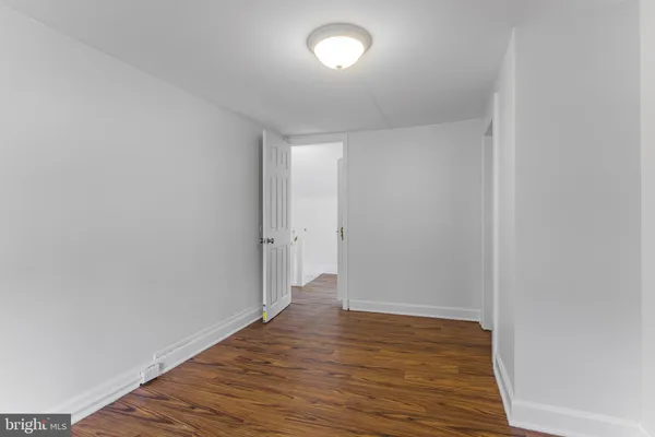 a view of an empty room and wooden floor