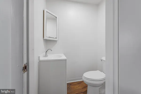 a bathroom with a sink a toilet and mirror