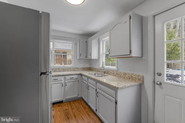 a kitchen with a sink stove and cabinets
