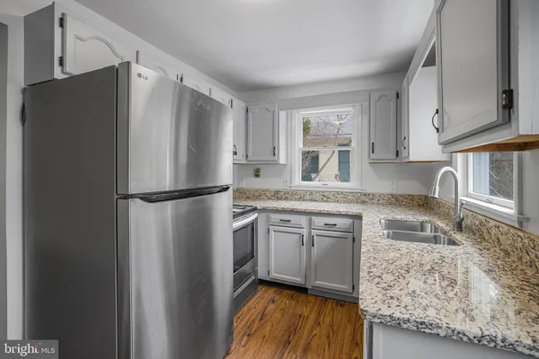 a kitchen with stainless steel appliances granite countertop a refrigerator and a sink