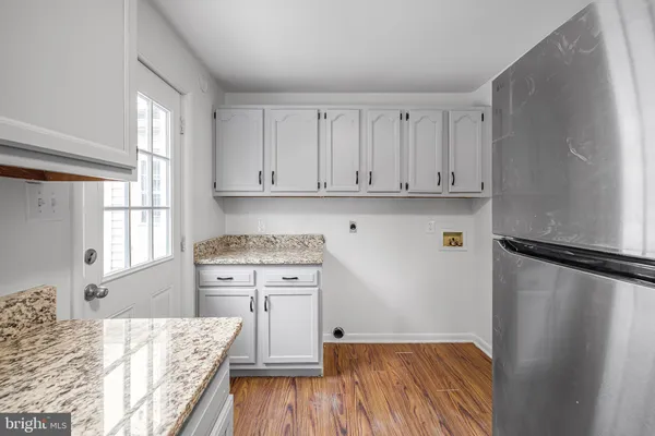 a view of a kitchen with wooden floor