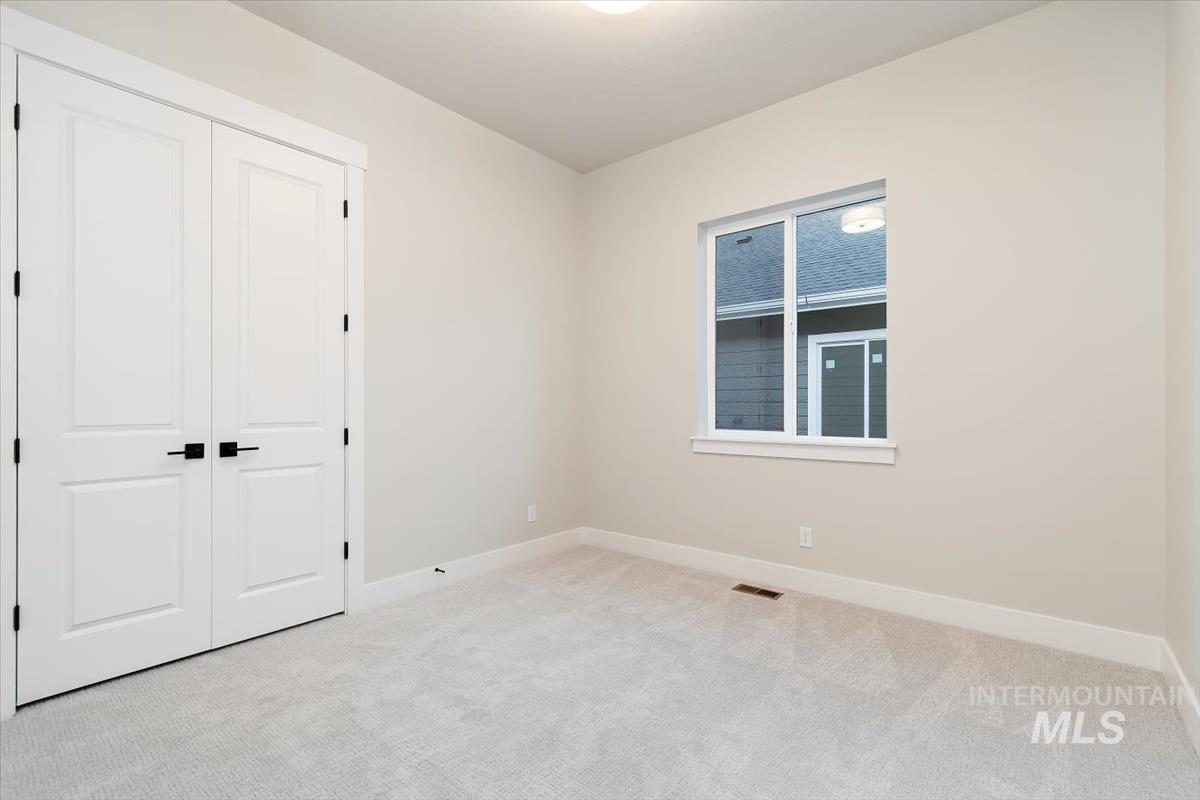 2147 East Blakehurst Avenue Kuna, ID 83634 - Photo 28 of 43 Unfurnished bedroom featuring carpet and a closet