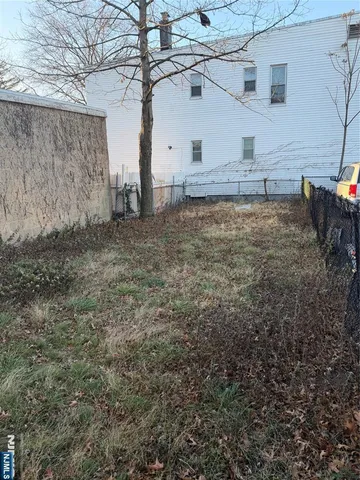 a view of a backyard with large trees