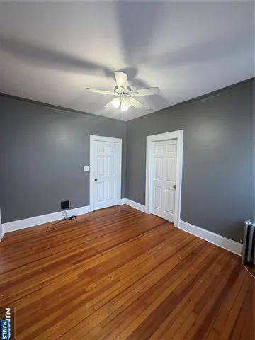 a bedroom with a bed and a ceiling fan