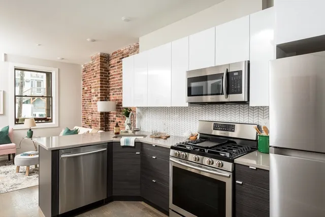 a kitchen with stainless steel appliances a stove a sink a stove microwave and refrigerator