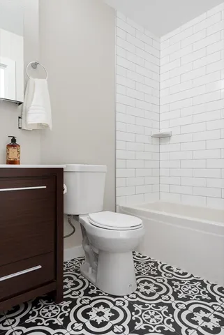 a bathroom with a toilet a sink and bathtub
