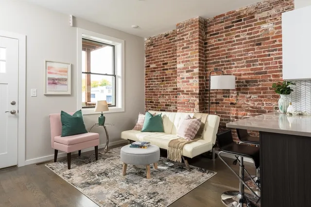 a living room with furniture two window and a table