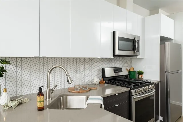 a kitchen with a microwave a stove and a refrigerator