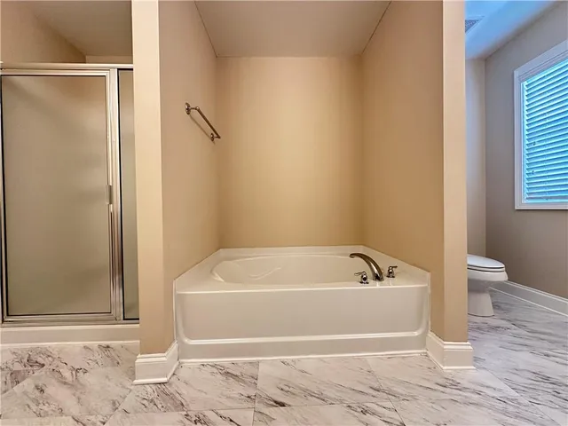 a bathroom with a bathtub and a window