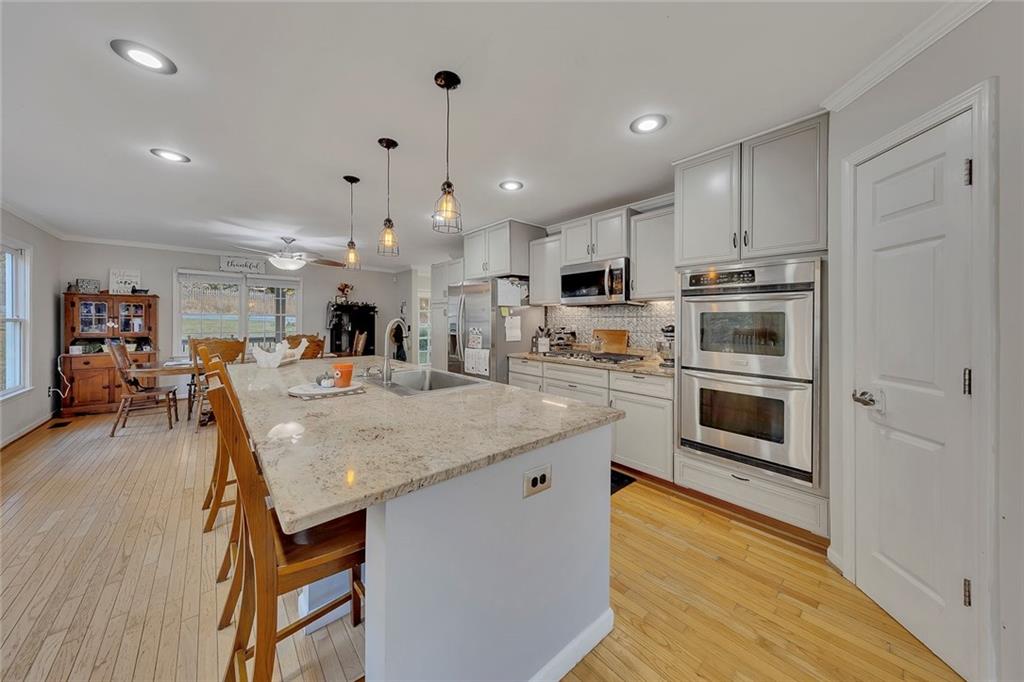 1620 Palm Street Canton, GA 30115 - Photo 15 of 72 a kitchen with stainless steel appliances granite countertop a stove refrigerator and a microwave