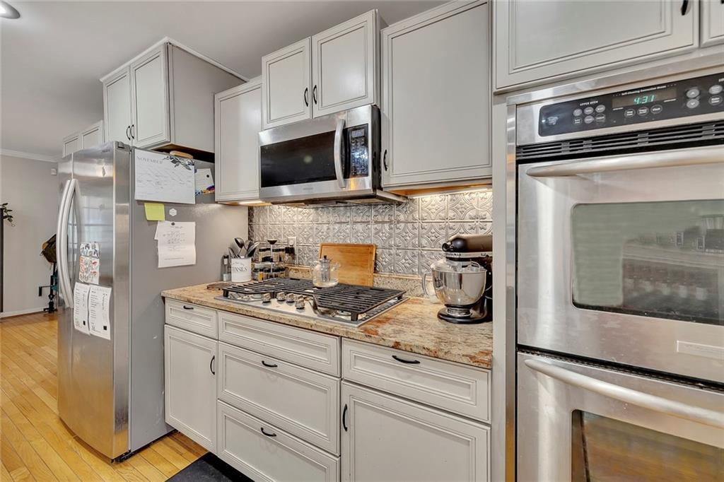 1620 Palm Street Canton, GA 30115 - Photo 16 of 72 a kitchen with stainless steel appliances a stove microwave and sink