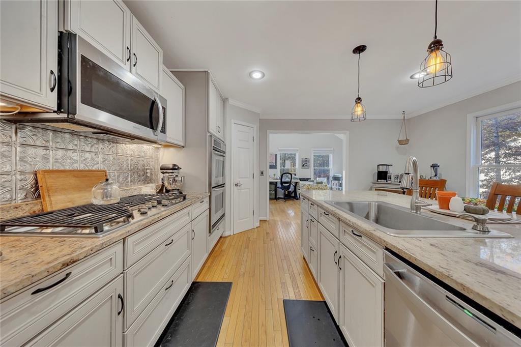 1620 Palm Street Canton, GA 30115 - Photo 18 of 72 a large kitchen with stainless steel appliances granite countertop a lot of counter space and wooden floor