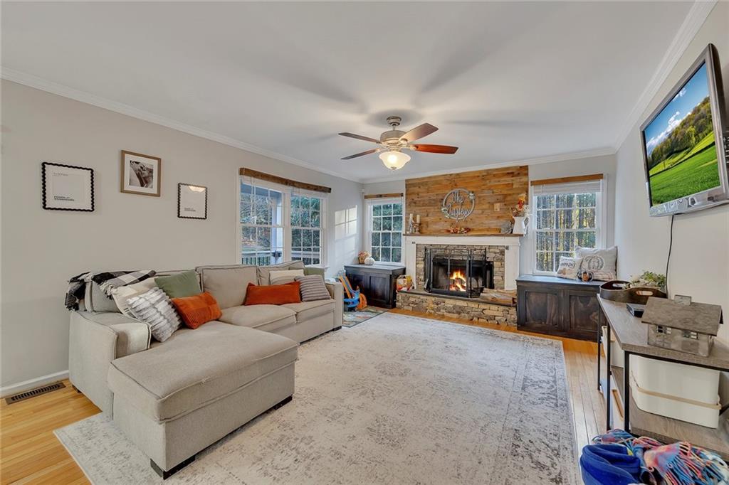 1620 Palm Street Canton, GA 30115 - Photo 23 of 72 a living room with furniture a flat screen tv and a fireplace