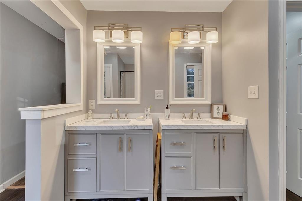 1620 Palm Street Canton, GA 30115 - Photo 28 of 72 a bathroom with a granite countertop sink a large mirror a and shower