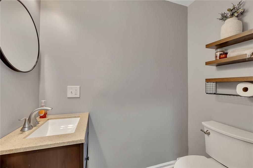 1620 Palm Street Canton, GA 30115 - Photo 30 of 72 a bathroom with a sink mirror and toilet