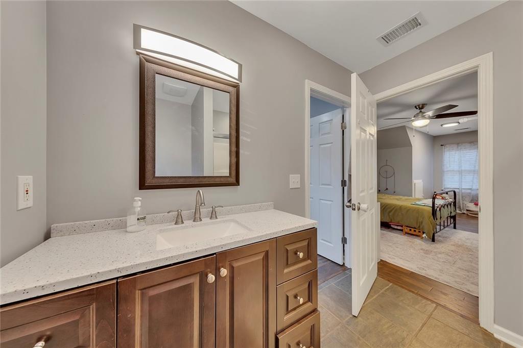 1620 Palm Street Canton, GA 30115 - Photo 38 of 72 a en suite bathroom with a sink and a mirror