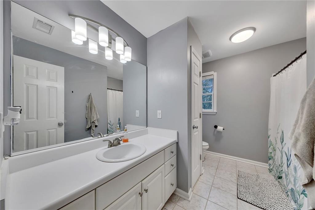 1620 Palm Street Canton, GA 30115 - Photo 42 of 72 a bathroom with a sink and a mirror
