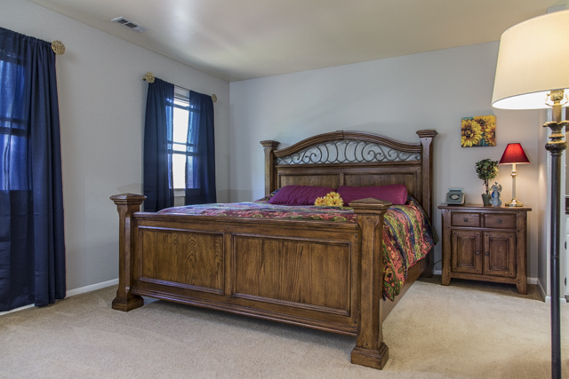 710 Heather Lane Bartlett, IL 60103 - Photo 17 of 26 a bed sitting in a bedroom next to a window