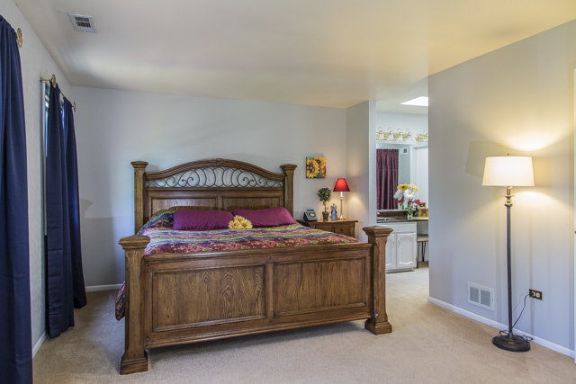 710 Heather Lane Bartlett, IL 60103 - Photo 18 of 26 a bedroom with a bed and a table