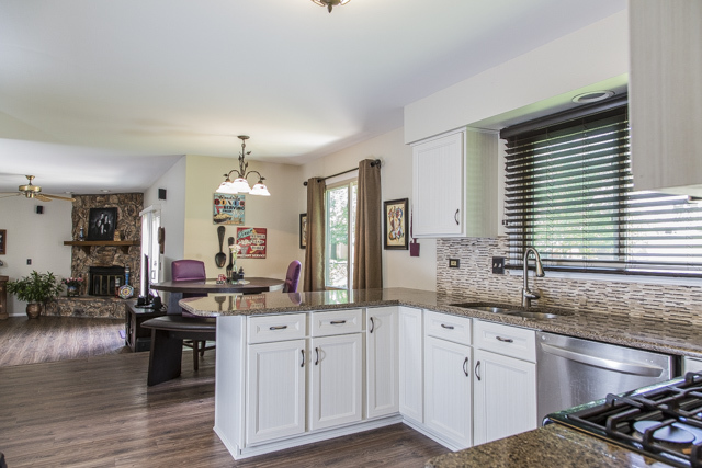 710 Heather Lane Bartlett, IL 60103 - Photo 4 of 26 a kitchen with stainless steel appliances granite countertop a sink cabinets and wooden floor