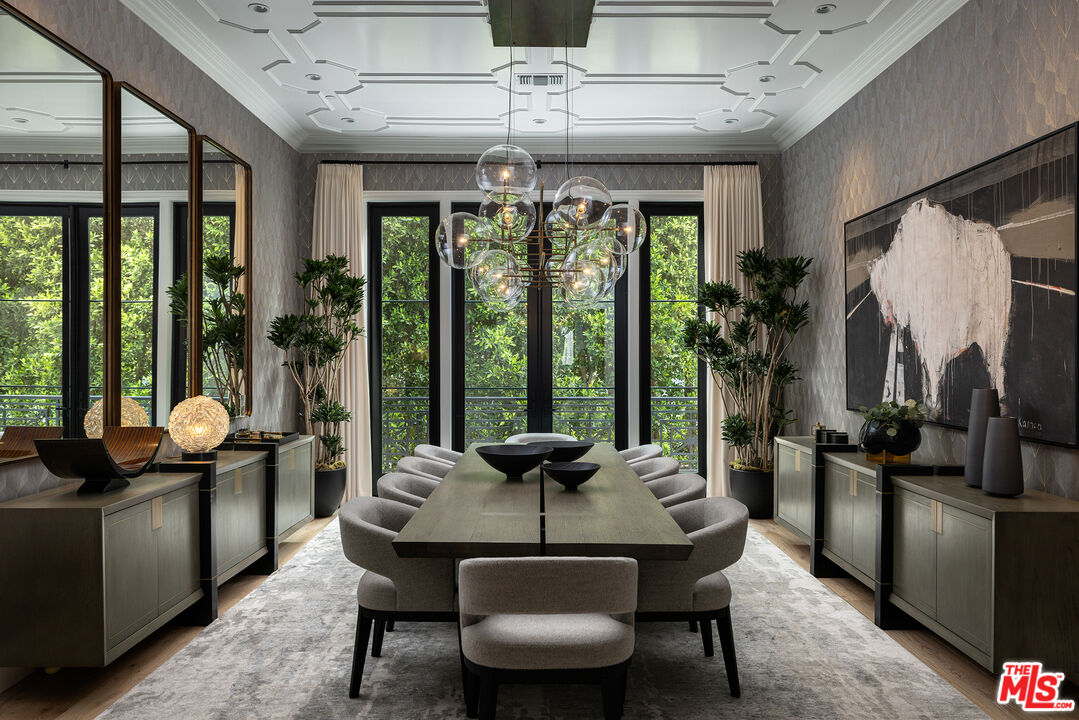 9520 Hidden Valley Road Beverly Hills, CA 90210 - Photo 12 of 29 a view of a dining room with furniture large windows and wooden floor