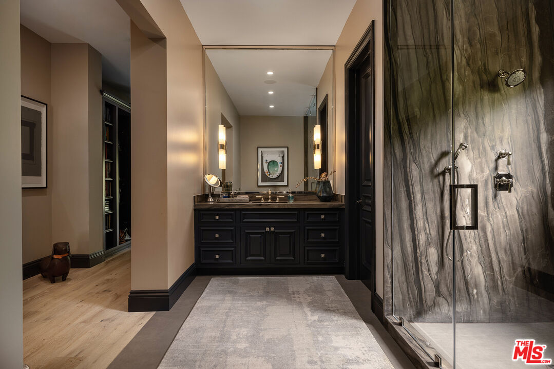 9520 Hidden Valley Road Beverly Hills, CA 90210 - Photo 15 of 29 a bathroom with a sink vanity and a mirror