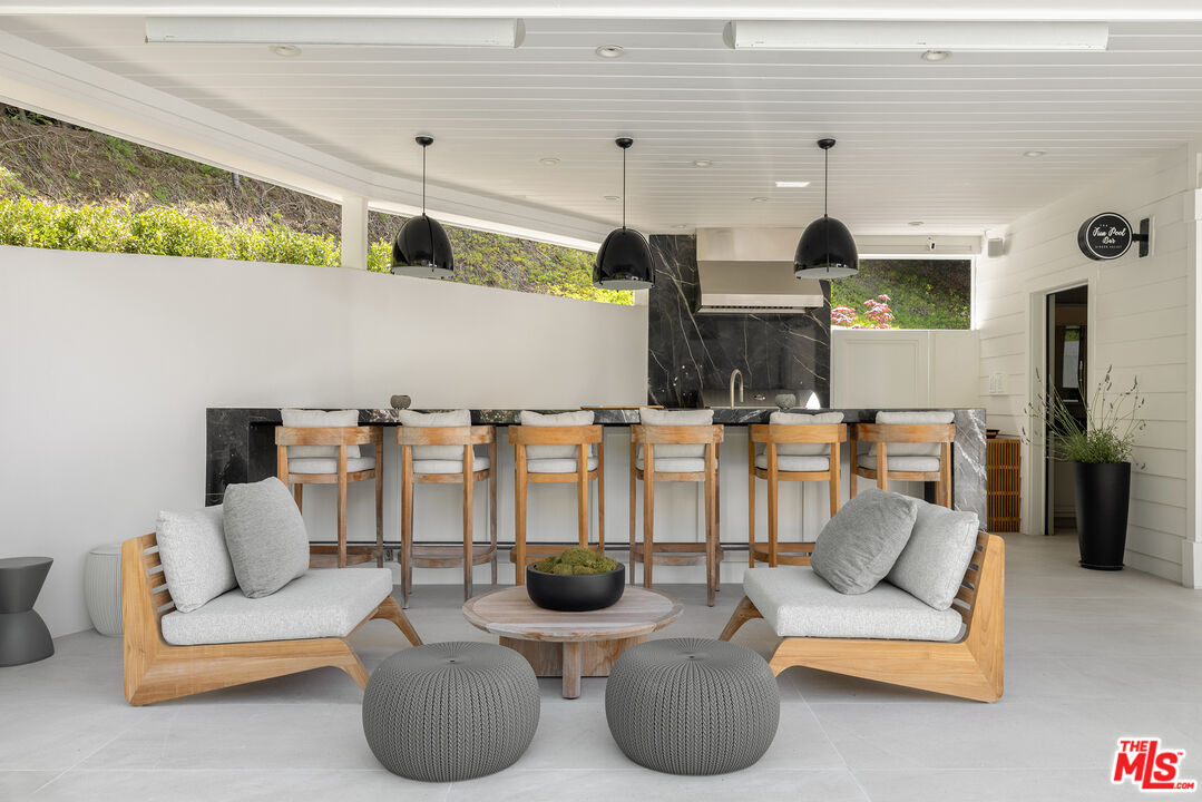 9520 Hidden Valley Road Beverly Hills, CA 90210 - Photo 10 of 29 a living room with furniture and flat screen tv