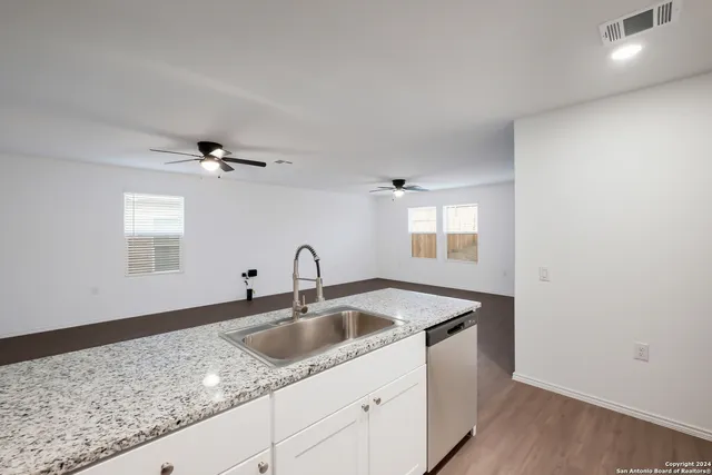 a kitchen with a sink and chandelier