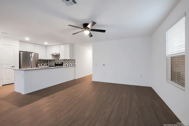 a view of a kitchen with a dishwasher and a refrigerator