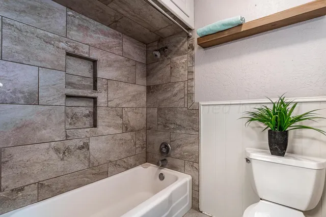 a bathroom with a bathtub and sink