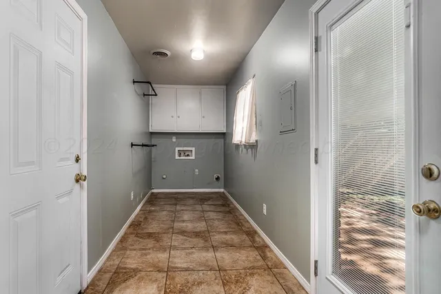 a view of a hallway with a kitchen
