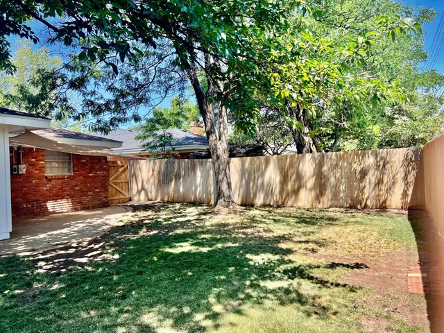 a view of outdoor space with deck and a yard