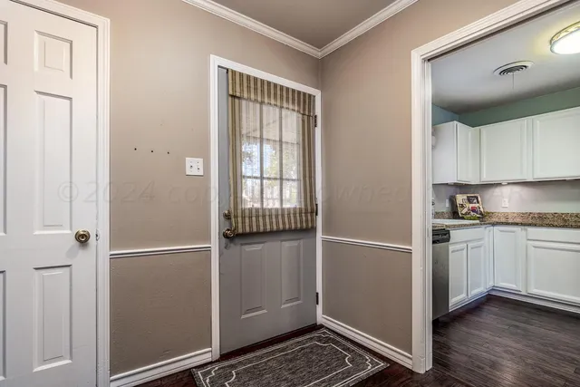 a kitchen with granite countertop cabinets and refrigerator