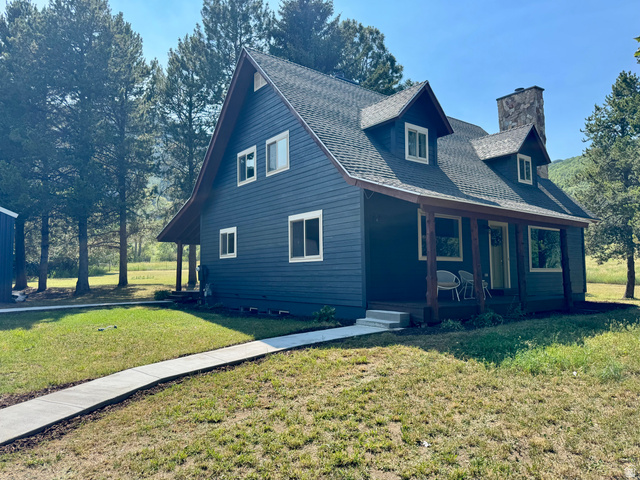 2807 North Ogden Canyon Road Eden, UT 84310 - Photo 4 of 72 Dark blue siding exterior with a covered porch featuring wood support beams