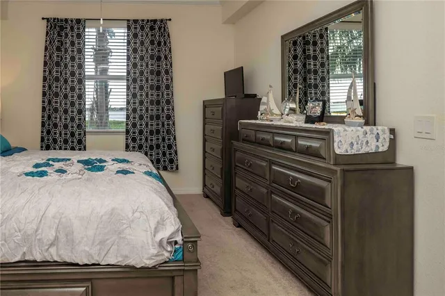 a bedroom with a bed and a lamp