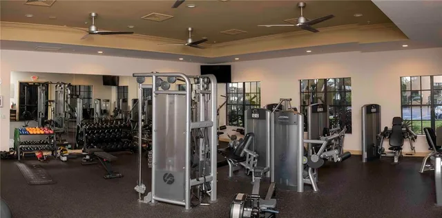 an aerial view of a house with swimming pool big yard and large trees