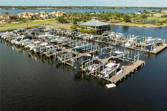 an aerial view of residential houses with outdoor space and lake view