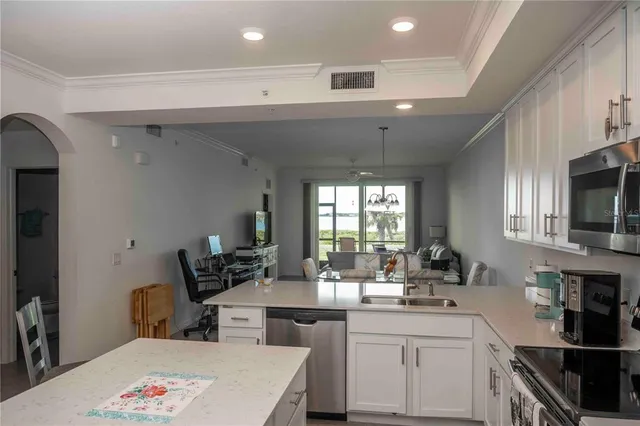 a view of a dining room with furniture and chandelier