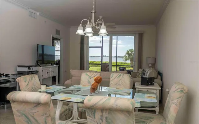 a living room with furniture a flat screen tv and a kitchen