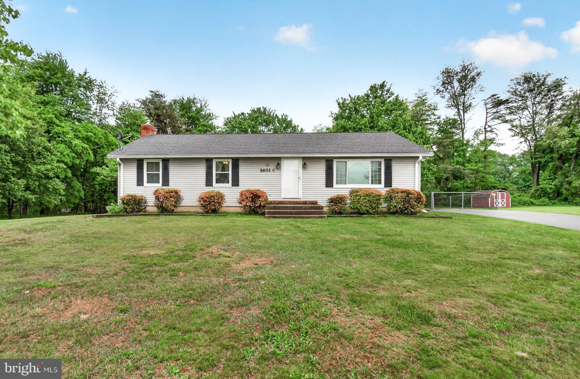 5601 Woodville Road Mount Airy, MD 21771 - Photo 4 of 54 a front view of a house with a yard