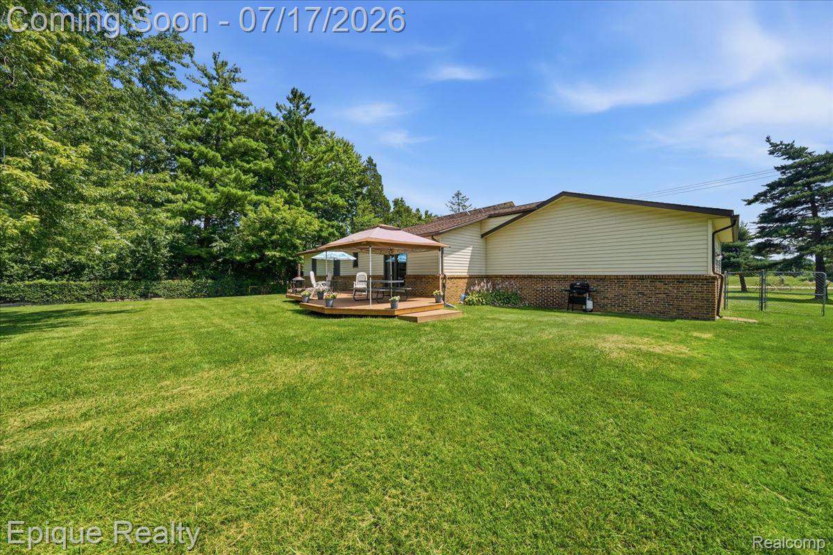555 East Square Lake Road Troy, MI 48085 - Photo 44 of 48 Expansive green lawn with mature trees bordering the property
