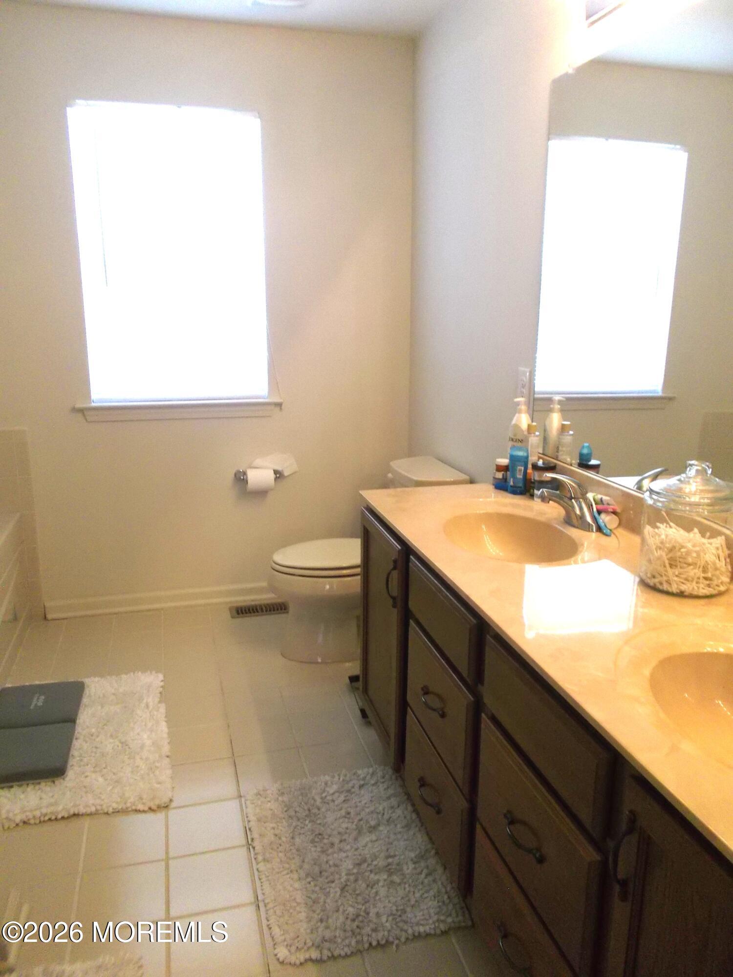 65 Homestead Drive Pemberton, NJ 08068 - Photo 15 of 26 a bathroom with a sink a toilet and a mirror