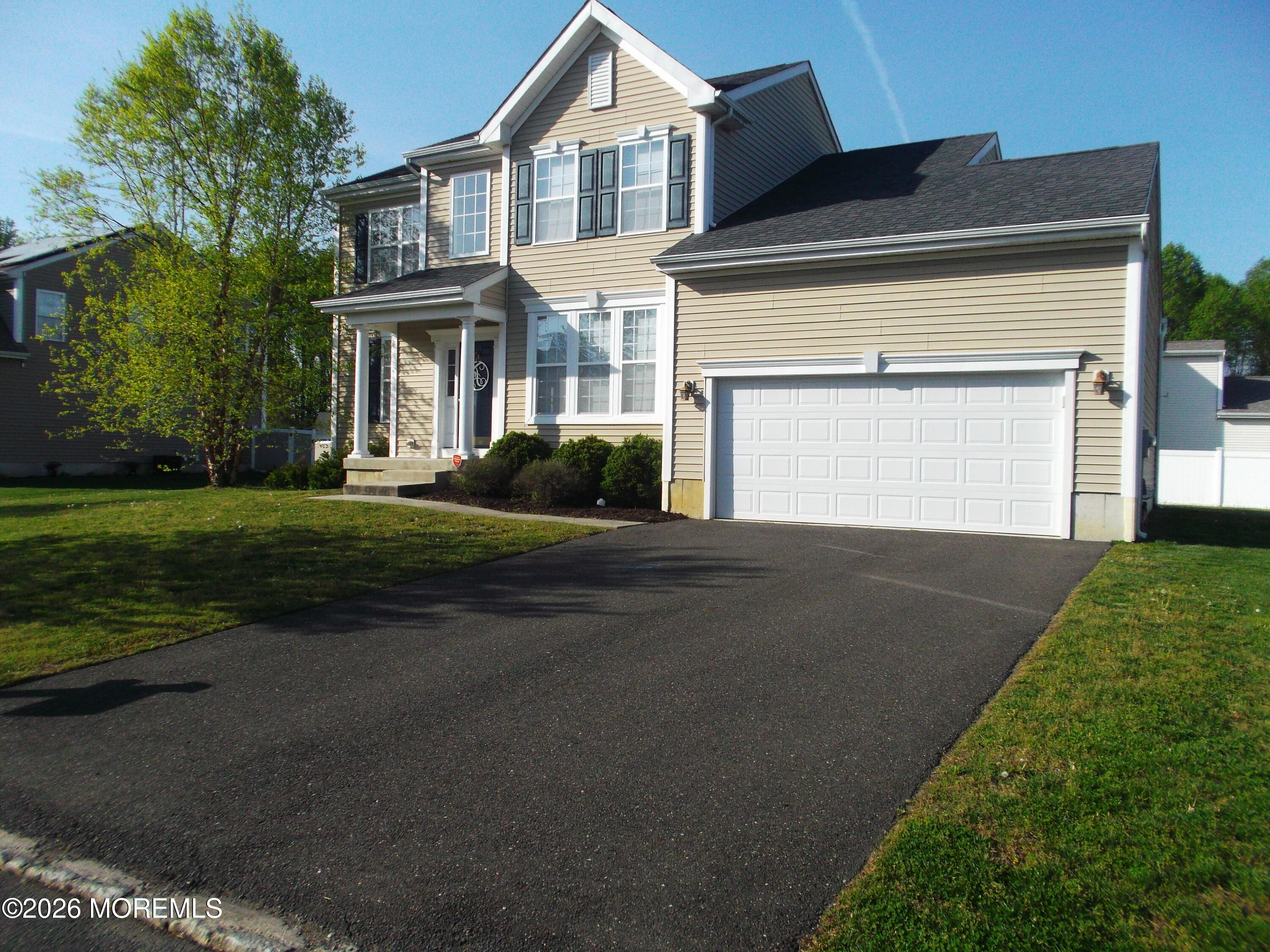 65 Homestead Drive Pemberton, NJ 08068 - Photo 2 of 26 a front view of a house with a yard and garage
