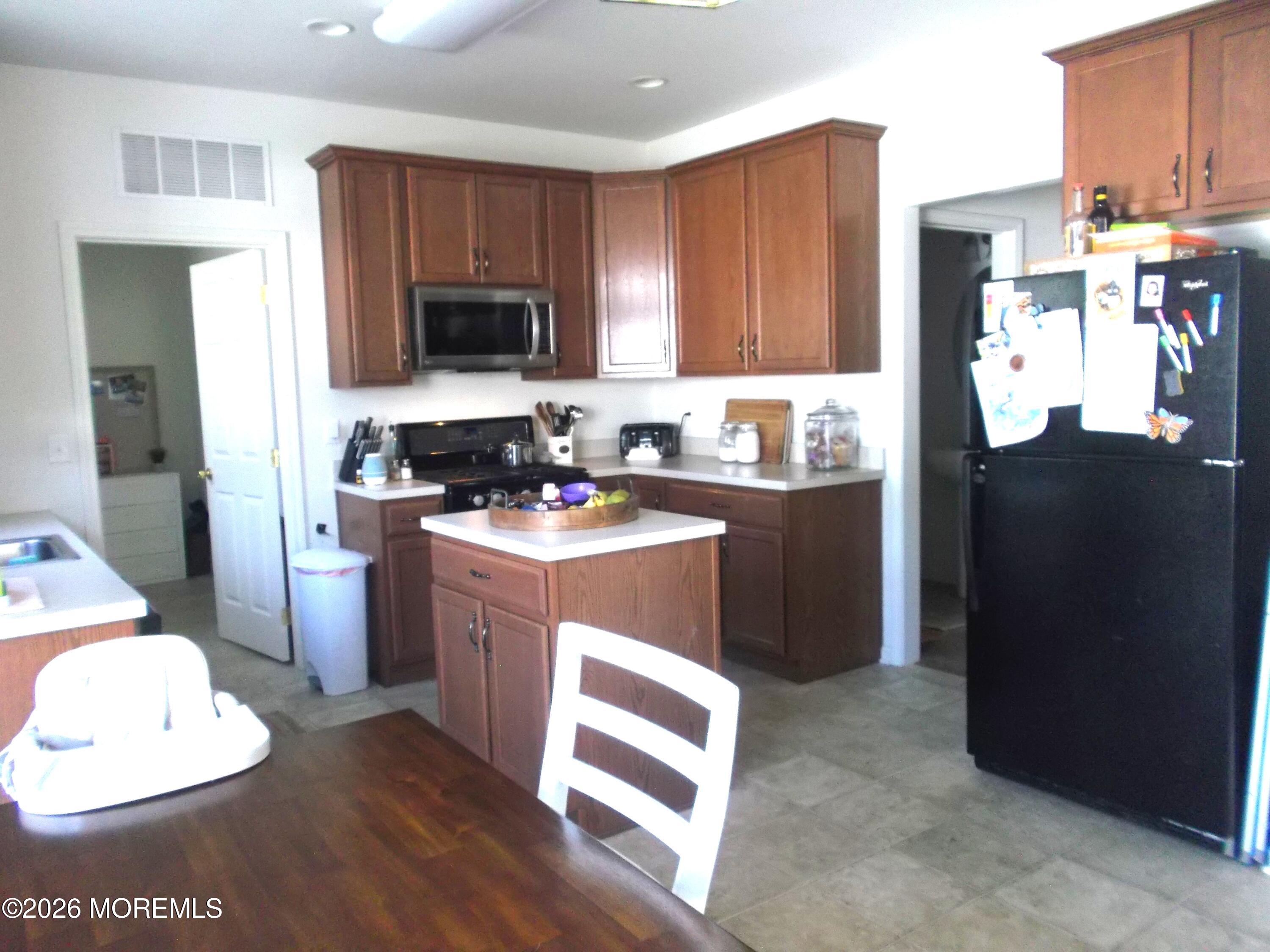 65 Homestead Drive Pemberton, NJ 08068 - Photo 5 of 26 a kitchen with a sink a stove a refrigerator cabinets and a dining table
