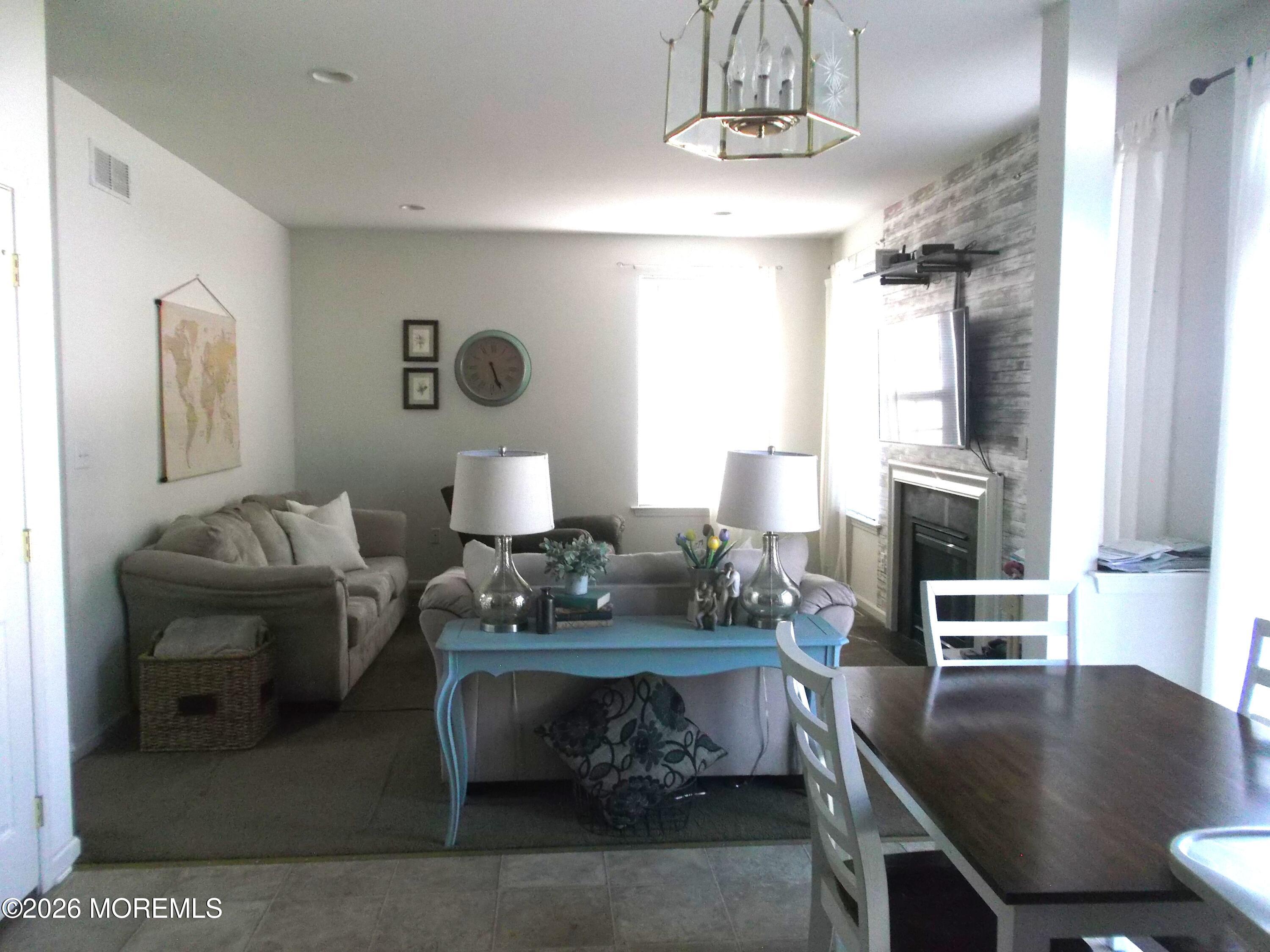 65 Homestead Drive Pemberton, NJ 08068 - Photo 6 of 26 a living room with furniture and chandelier