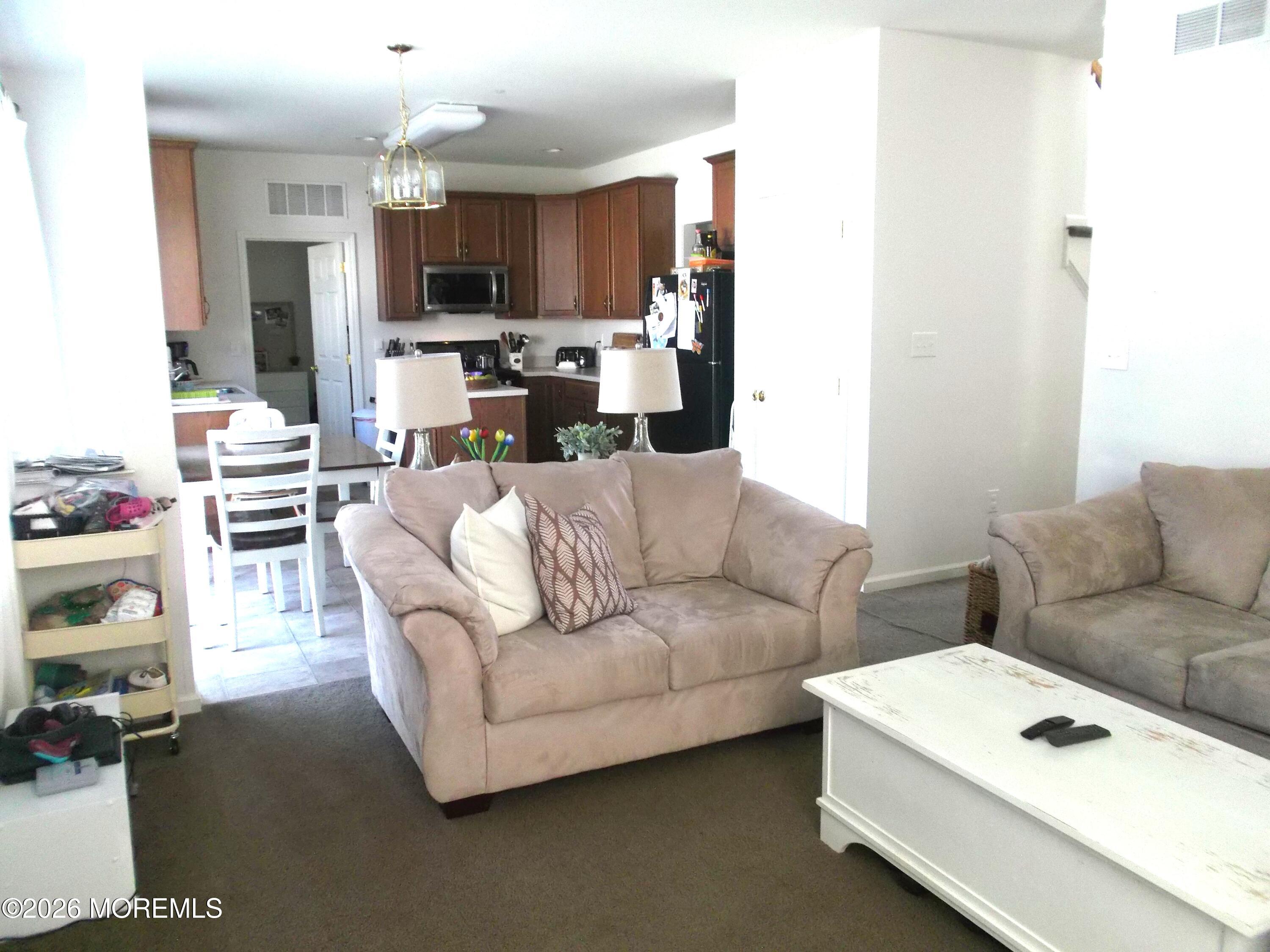 65 Homestead Drive Pemberton, NJ 08068 - Photo 7 of 26 a living room with furniture and a flat screen tv