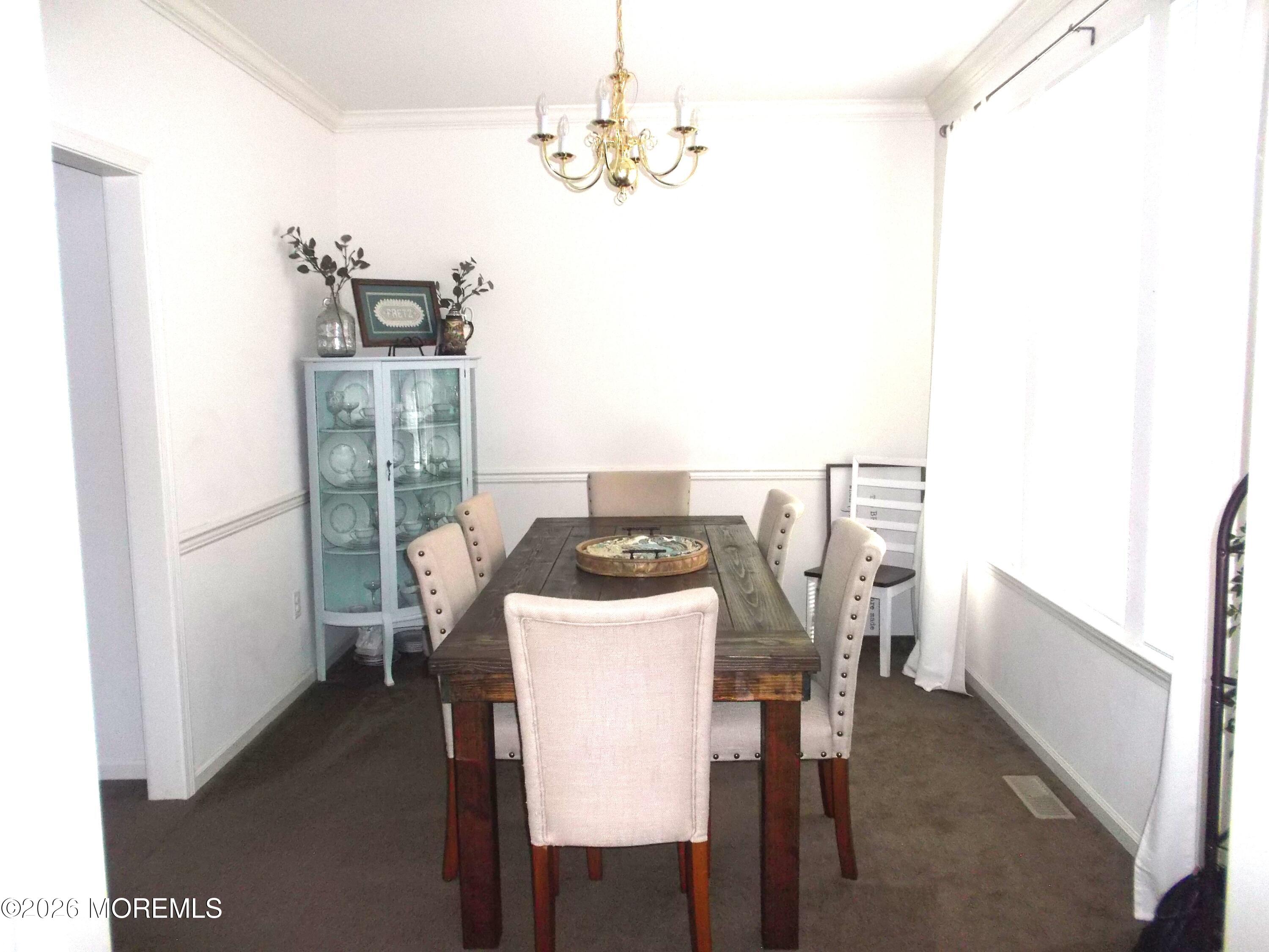 65 Homestead Drive Pemberton, NJ 08068 - Photo 8 of 26 a dining room with furniture and chandelier